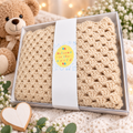 Beige handmade crochet baby blanket presented in a gift box